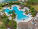 Community pool with unique design and surrounding landscaping at 14350 Easy Goer St, Ruskin, FL 33573
