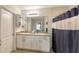 Clean bathroom with double sinks, shower, and plenty of storage at 15812 High Bell Pl, Bradenton, FL 34212