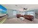 Versatile bonus room with leather couches, large TV and ping pong table at 15812 High Bell Pl, Bradenton, FL 34212