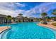 Large community pool with adjacent clubhouse at 15812 High Bell Pl, Bradenton, FL 34212