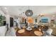 Round dining table with gray chairs, overlooking living room at 15812 High Bell Pl, Bradenton, FL 34212