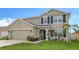 Two-story house with a green facade, landscaping, and a two-car garage at 15812 High Bell Pl, Bradenton, FL 34212
