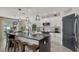 Modern kitchen with white cabinets, a large island, and dark countertops at 15812 High Bell Pl, Bradenton, FL 34212