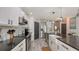 Modern kitchen with white cabinets, a large island, and dark countertops at 15812 High Bell Pl, Bradenton, FL 34212