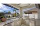 Outdoor kitchen with grill, sink, and granite countertop at 15812 High Bell Pl, Bradenton, FL 34212