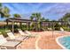 Relaxing pool area with lounge chairs and shaded pergolas at 15812 High Bell Pl, Bradenton, FL 34212