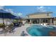 Resort-style pool with lounge chairs and patio umbrellas at 15812 High Bell Pl, Bradenton, FL 34212
