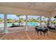 Covered poolside seating with tables and chairs at 15812 High Bell Pl, Bradenton, FL 34212