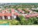 Aerial view showcasing community buildings and tennis court at 1626 Stickney Point Rd # 26-102, Sarasota, FL 34231