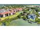 Wide aerial view of community, tennis court, and waterfront at 1626 Stickney Point Rd # 26-102, Sarasota, FL 34231