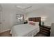 Cozy bedroom with a queen-size bed and dark wood-look floors at 1626 Stickney Point Rd # 26-102, Sarasota, FL 34231