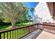 Private deck overlooking a lush lawn and tennis courts at 1626 Stickney Point Rd # 26-102, Sarasota, FL 34231