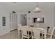 Open concept dining area with white table and chairs at 1626 Stickney Point Rd # 26-102, Sarasota, FL 34231