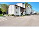 Condo building exterior with parking and landscaping at 1626 Stickney Point Rd # 26-102, Sarasota, FL 34231