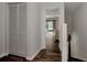 Bright hallway with a built-in closet and dark wood-look floors at 1626 Stickney Point Rd # 26-102, Sarasota, FL 34231
