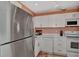 Modern kitchen featuring white cabinets and quartz countertops at 1626 Stickney Point Rd # 26-102, Sarasota, FL 34231