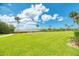 Expansive grassy lawn area with water views at 1626 Stickney Point Rd # 26-102, Sarasota, FL 34231