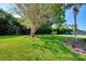 Landscaped lawn area with mature trees and lush greenery at 1626 Stickney Point Rd # 26-102, Sarasota, FL 34231