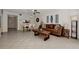 Spacious living room with a brown leather couch and tiled floor at 1626 Stickney Point Rd # 26-102, Sarasota, FL 34231