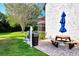 Private patio with picnic table, grill, and blue umbrella at 1626 Stickney Point Rd # 26-102, Sarasota, FL 34231