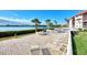 Community patio with lounge chairs and waterfront view at 1626 Stickney Point Rd # 26-102, Sarasota, FL 34231