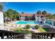 Refreshing community pool surrounded by lush landscaping at 1626 Stickney Point Rd # 26-102, Sarasota, FL 34231