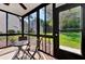 Bright screened porch features a small table and chairs at 1626 Stickney Point Rd # 26-102, Sarasota, FL 34231