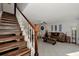 Wooden staircase with white railing leading to upper level at 1626 Stickney Point Rd # 26-102, Sarasota, FL 34231
