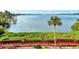Stunning waterfront view with walkway and lush landscaping at 1626 Stickney Point Rd # 26-102, Sarasota, FL 34231