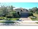 Single-story home with tile roof, gray garage door, and landscaped yard at 17016 Seaford Way, Bradenton, FL 34202