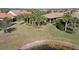 Aerial view of property near a lake with palm trees and grass at 17016 Seaford Way, Bradenton, FL 34202