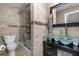 Bathroom with glass-top vanity and walk-in shower at 1726 Killdeer Cir, Venice, FL 34293