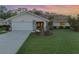 Single-story home with attached garage, landscaping, and a terracotta roof at 1726 Killdeer Cir, Venice, FL 34293