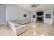 Living room features a stone fireplace and neutral color palette at 1726 Killdeer Cir, Venice, FL 34293