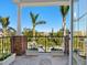 Private balcony with brick flooring and lush tropical views at 1810 Lincoln Dr, Sarasota, FL 34236