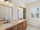 Double vanity bathroom with granite countertop and tiled floor at 1810 Lincoln Dr, Sarasota, FL 34236