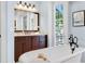Spa-like bathroom with a freestanding tub and double vanity at 1810 Lincoln Dr, Sarasota, FL 34236