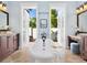 Elegant bathroom with freestanding soaking tub and double vanities, opening to a private courtyard at 1810 Lincoln Dr, Sarasota, FL 34236