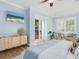 Light and airy bedroom with a king-size bed, light blue walls, and French doors leading to the patio at 1810 Lincoln Dr, Sarasota, FL 34236