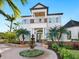 Two-story house with white exterior, blue shutters, and a brick walkway at 1810 Lincoln Dr, Sarasota, FL 34236