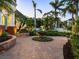 Landscaped front yard with fountain and brick pavers at 1810 Lincoln Dr, Sarasota, FL 34236