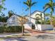 Two-story home with white siding, landscaping, and palm trees at 1810 Lincoln Dr, Sarasota, FL 34236