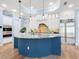 Modern kitchen with stainless steel appliances and a curved blue island at 1810 Lincoln Dr, Sarasota, FL 34236