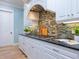 White kitchen features a gas cooktop and a stylish backsplash at 1810 Lincoln Dr, Sarasota, FL 34236