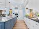 Modern kitchen with white cabinets, granite countertops, and a gas cooktop at 1810 Lincoln Dr, Sarasota, FL 34236