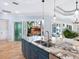 Kitchen island with granite countertop and double sink overlooking the pool at 1810 Lincoln Dr, Sarasota, FL 34236