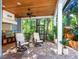 Outdoor kitchen and lanai with seating and tropical views at 1810 Lincoln Dr, Sarasota, FL 34236