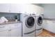 Bright laundry room features white cabinets, granite counters, and a Whirlpool washer and dryer at 1810 Lincoln Dr, Sarasota, FL 34236