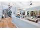 Light and airy living room with hardwood floors, a curved staircase, and a half wall at 1810 Lincoln Dr, Sarasota, FL 34236