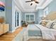 Spacious main bedroom with hardwood floors, a ceiling fan, and plenty of natural light at 1810 Lincoln Dr, Sarasota, FL 34236